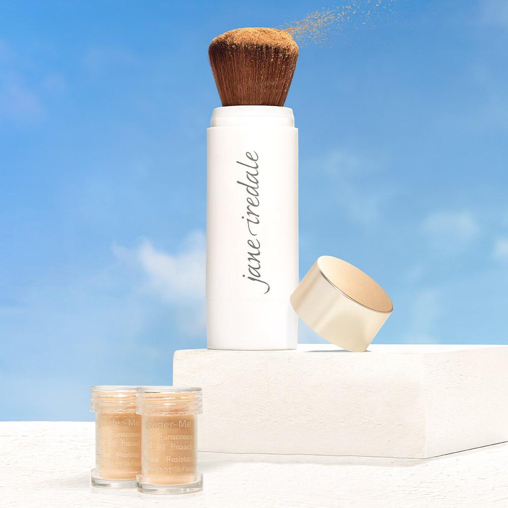 Jane-Iredale-Powder-Me-Dry-Sunscreen-SPF30 A bottle of foundation and two jars on top of a table.