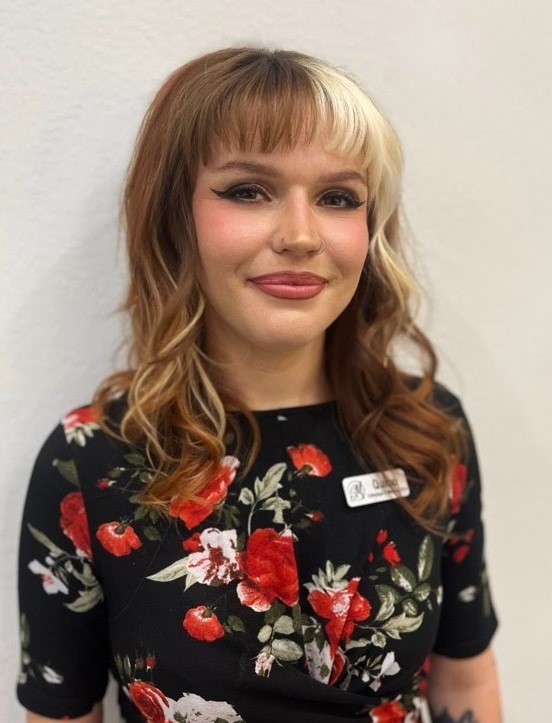 A woman with long blonde hair and bangs.